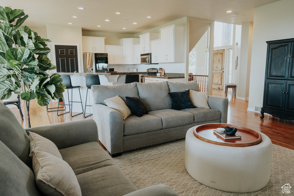 Living area featuring light wood-style floors and recessed lighting