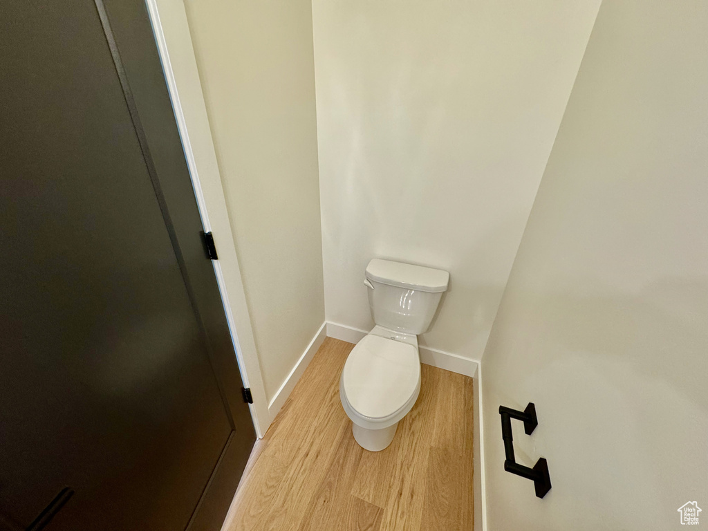 Bathroom featuring toilet and wood finished floors