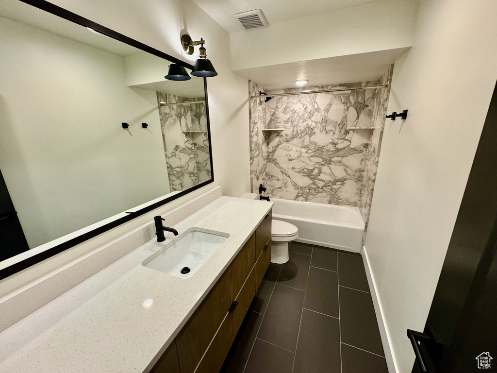Bathroom with vanity, shower / tub combination, and tile patterned floors