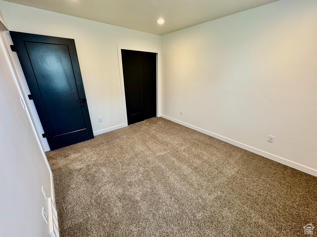 Unfurnished bedroom with carpet flooring and recessed lighting