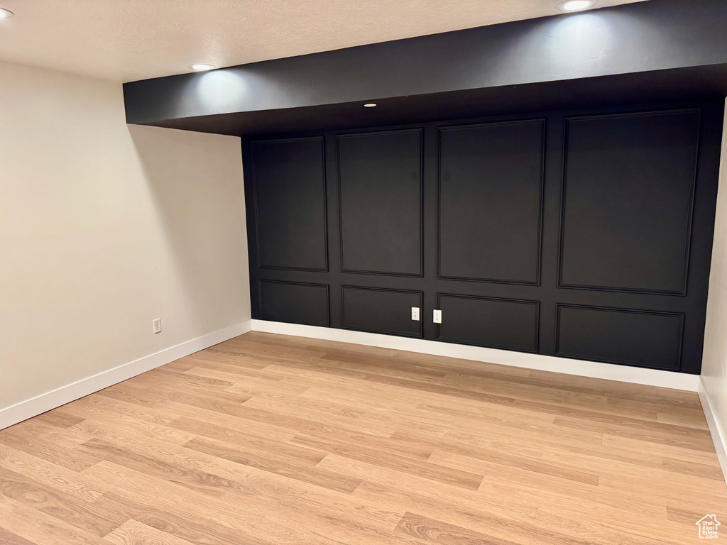 Empty room featuring light wood-style floors and recessed lighting