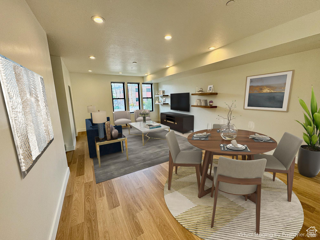 Dining room with light wood-type flooring and recessed lighting