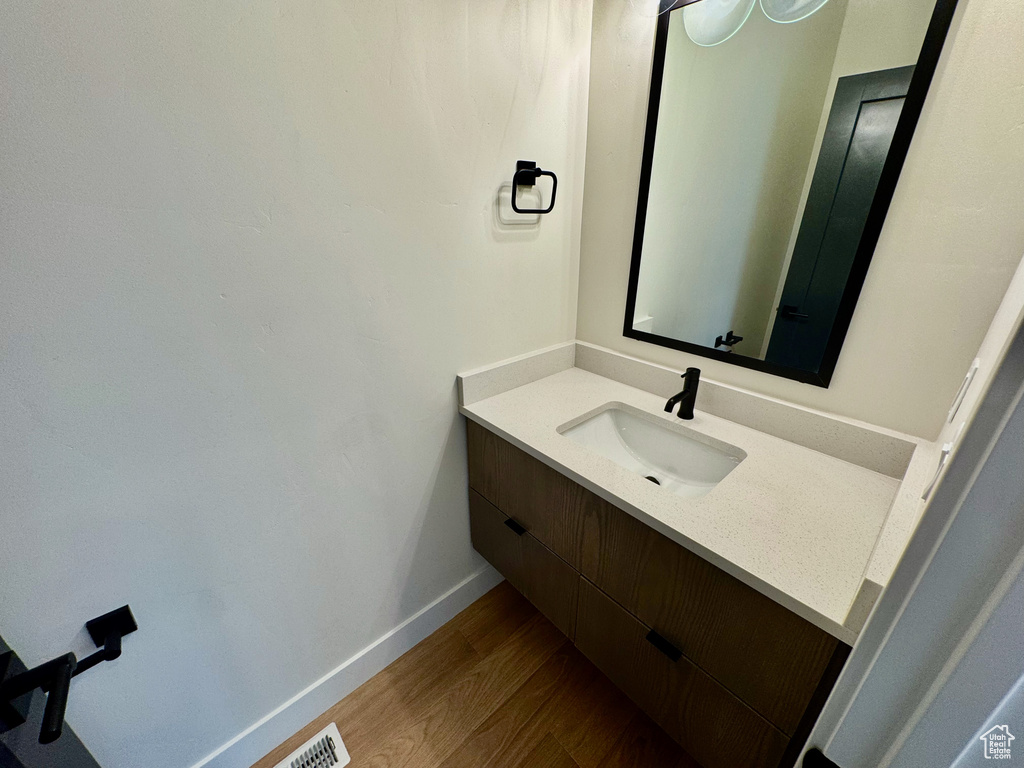 Bathroom with vanity and wood finished floors