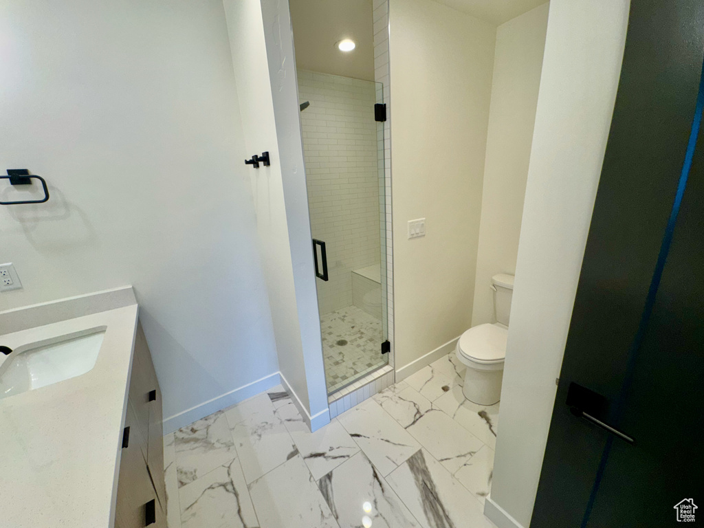 Full bathroom with vanity, a shower stall, marble look tile flooring, and recessed lighting