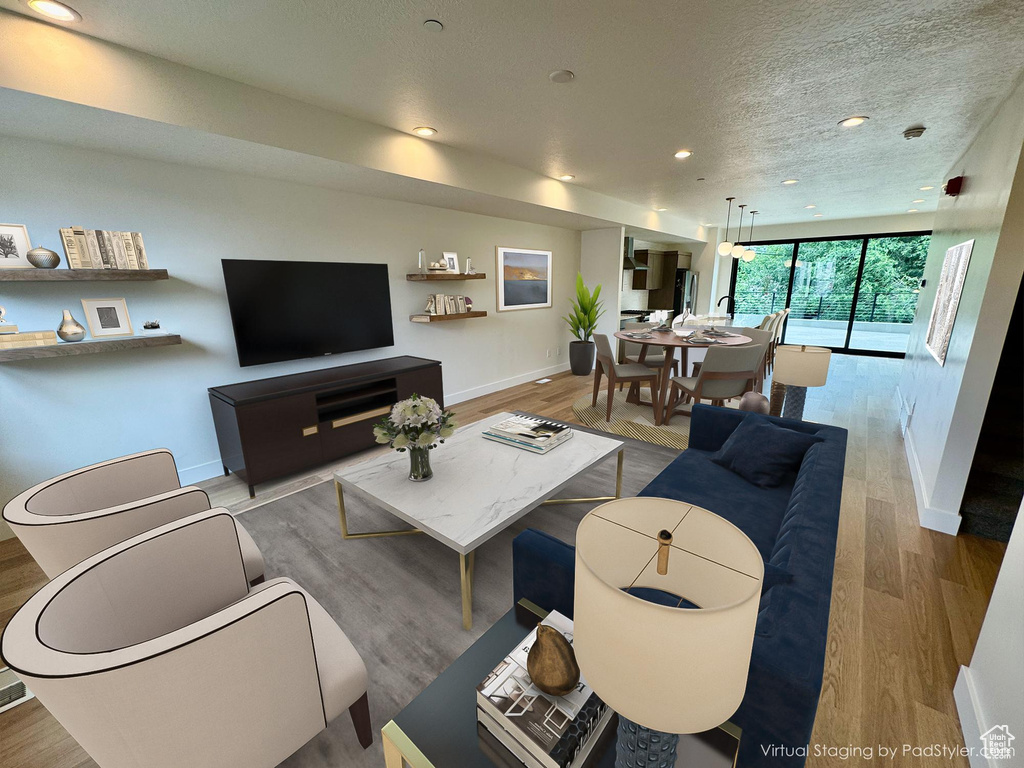 Living room featuring wood finished floors, recessed lighting, and a textured ceiling