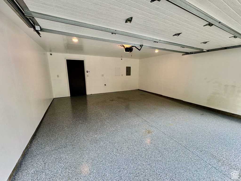 Garage with a garage door opener and electric panel