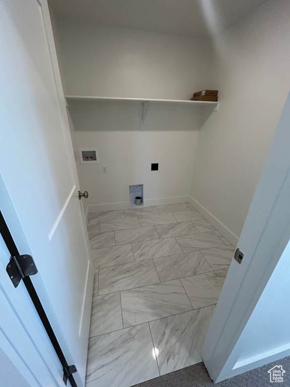 Laundry area featuring hookup for a washing machine, light marble finish flooring, and electric dryer hookup