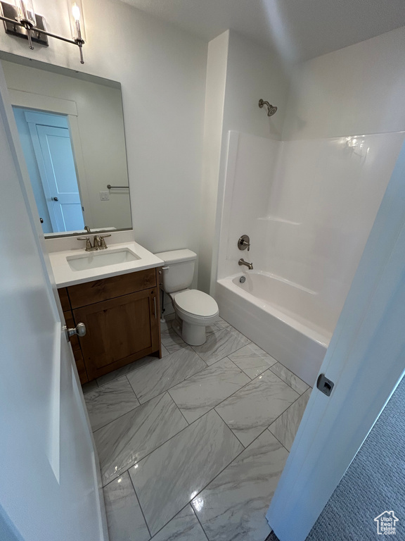 Bathroom featuring vanity, shower / bathtub combination, and marble look tile flooring