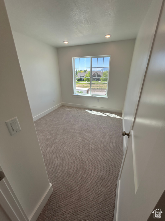 Carpeted empty room featuring recessed lighting and a textured ceiling