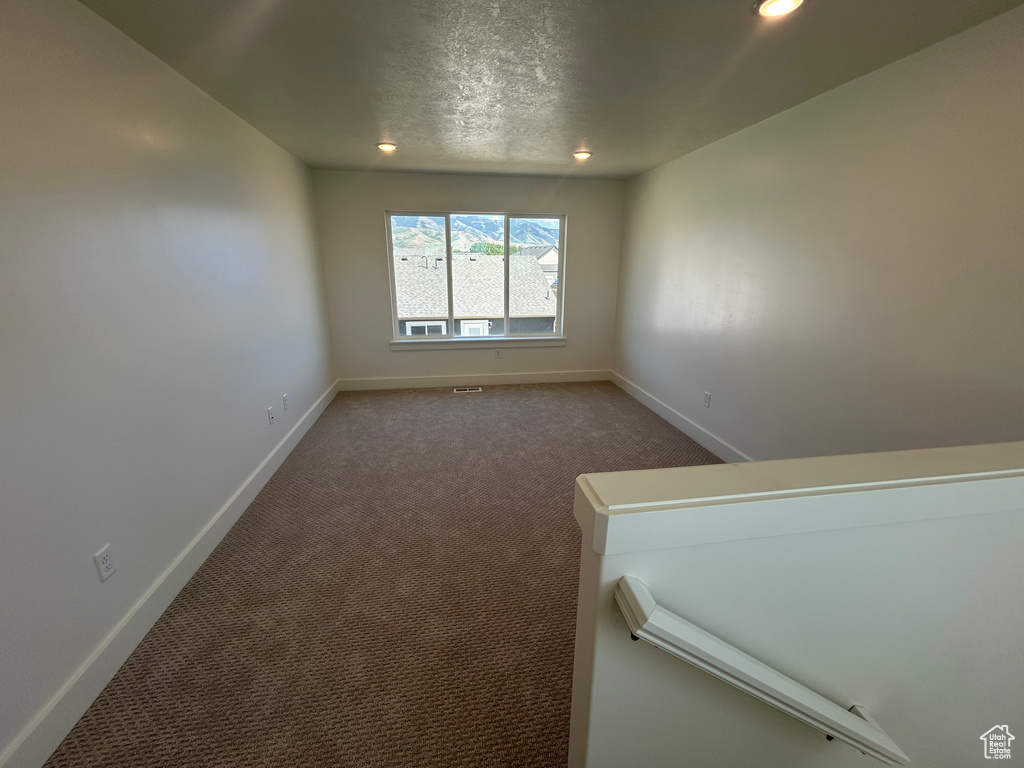 Spare room featuring recessed lighting, carpet flooring, and a textured ceiling