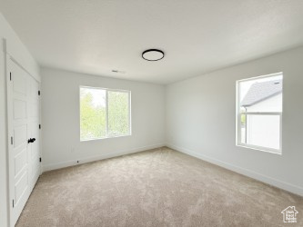 Unfurnished bedroom with carpet flooring and baseboards