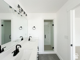 Bathroom with double vanity and a stall shower