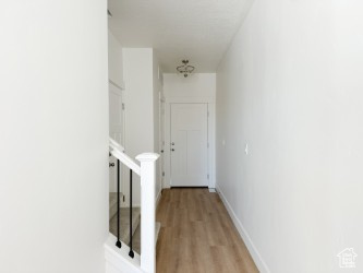 Hall featuring light wood-style floors and stairway