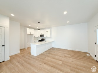 Unfurnished living room with recessed lighting and light wood-style flooring