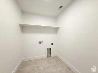 Washroom with washer hookup, light carpet, and hookup for an electric dryer