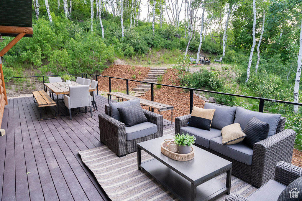 Wooden deck with outdoor dining space and outdoor lounge area