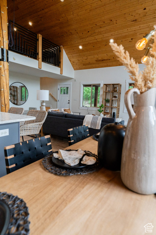 Living room featuring wooden ceiling, high vaulted ceiling, recessed lighting, and wood finished floors