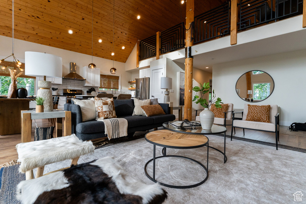 Living area with high vaulted ceiling, wooden ceiling, and recessed lighting