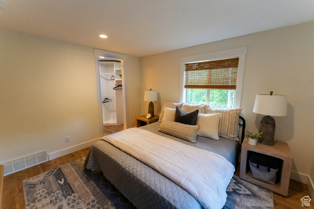 Bedroom with wood finished floors and recessed lighting