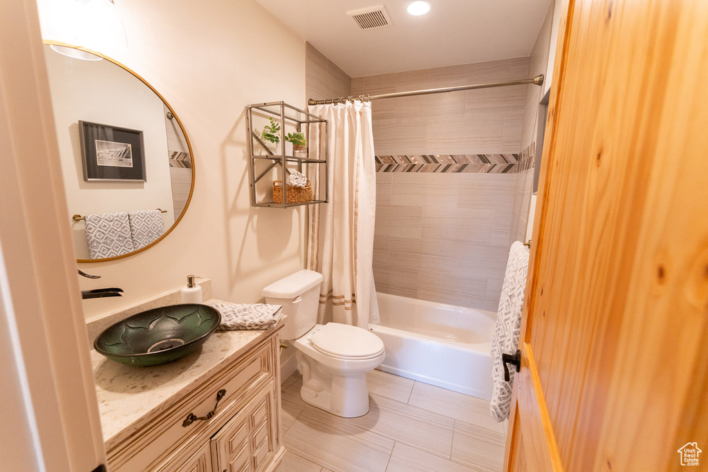 Full bath featuring vanity and shower / bath combo with shower curtain