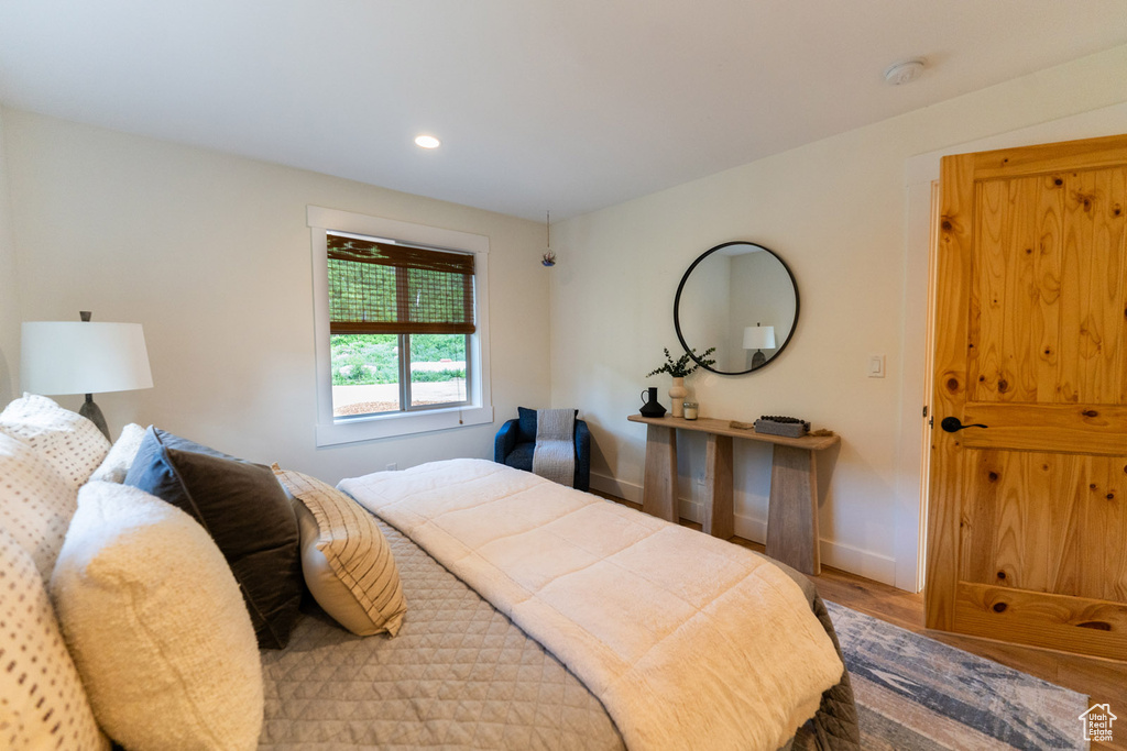 Bedroom with wood finished floors and recessed lighting