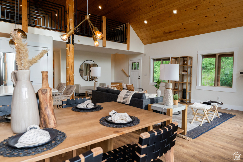 Dining area with wooden ceiling, high vaulted ceiling, recessed lighting, and wood finished floors