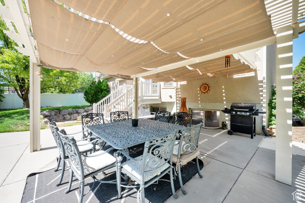 View of patio / terrace featuring outdoor dining area, stairway, and grilling area