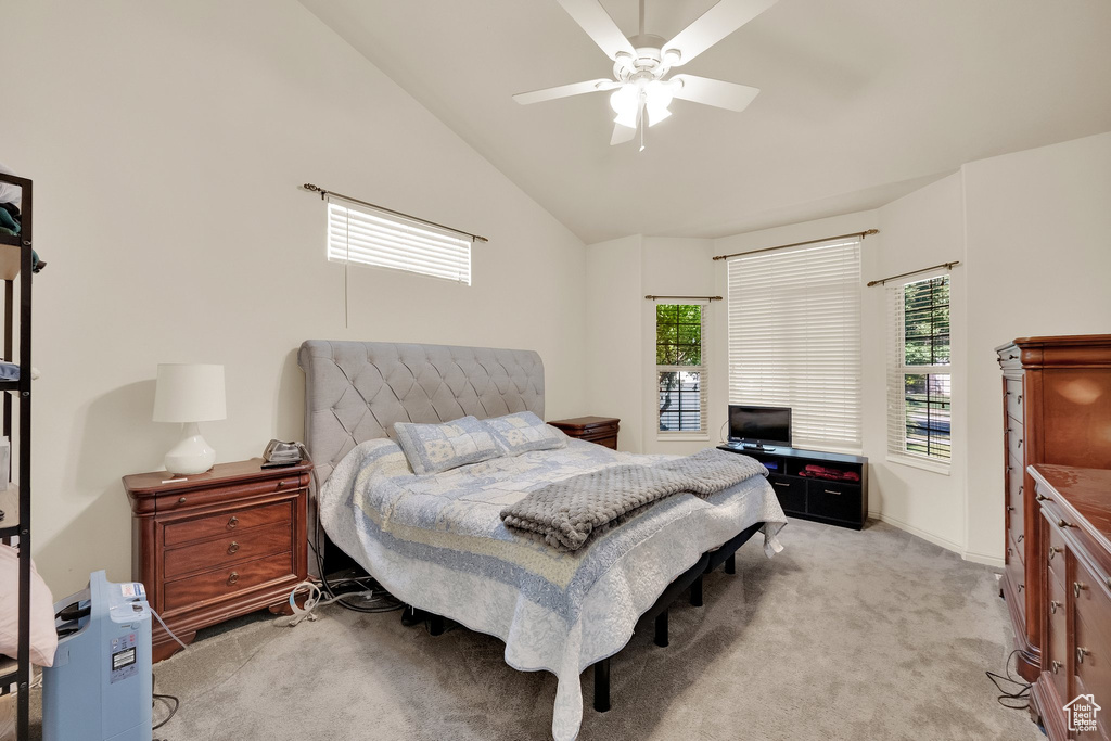 Bedroom with light carpet, lofted ceiling, and ceiling fan