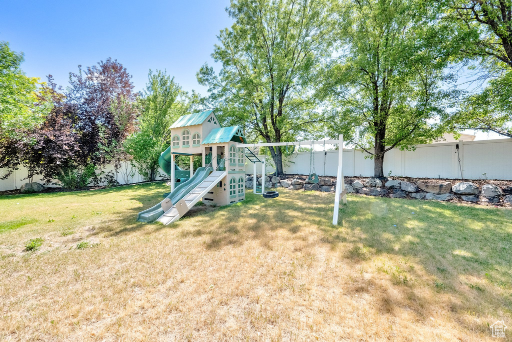 Fenced backyard with a playground