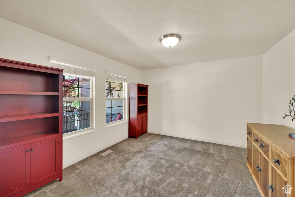 Unfurnished room with carpet floors and baseboards