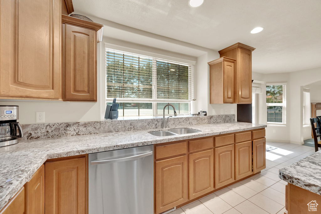 Kitchen featuring dishwasher, light tile patterned floors, light stone counters, recessed lighting, and light brown cabinets