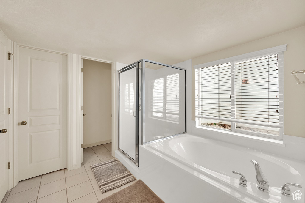 Bathroom with a shower stall, a garden tub, and tile patterned flooring