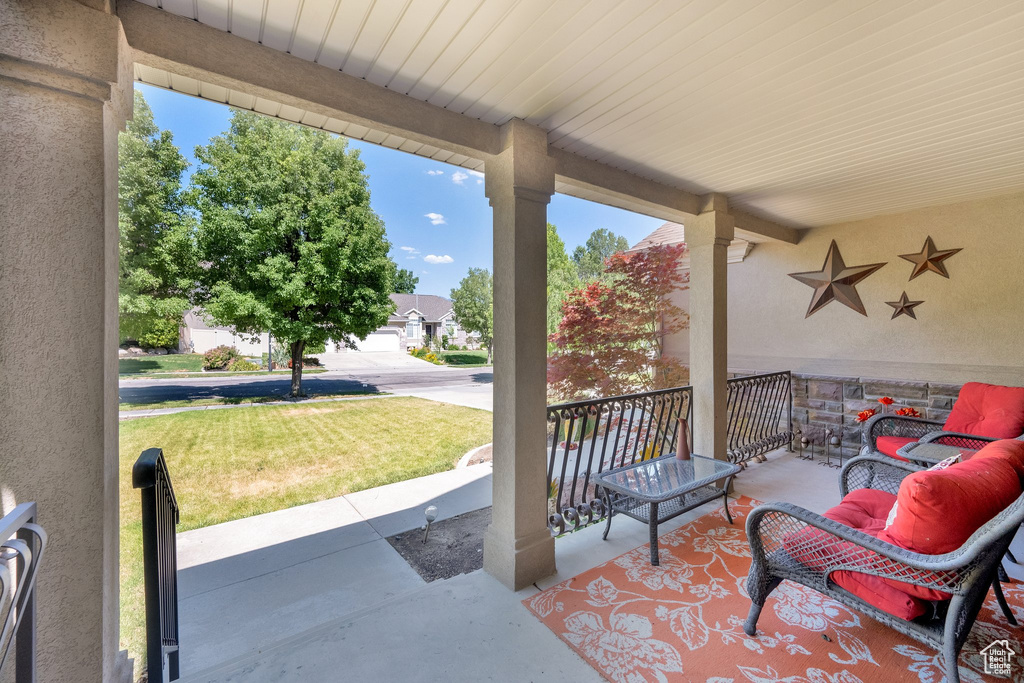 Porch with a lawn and an outdoor hangout area