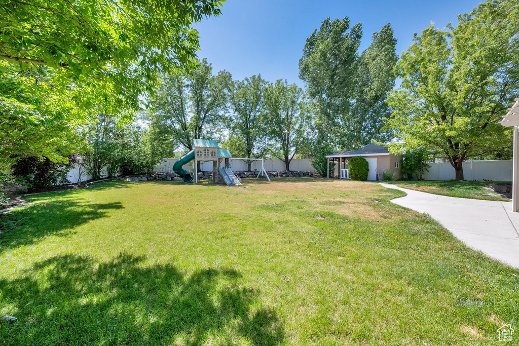 Fenced yard featuring a playground