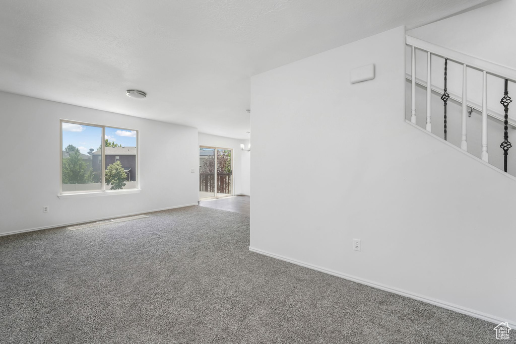 Unfurnished room featuring carpet flooring and baseboards