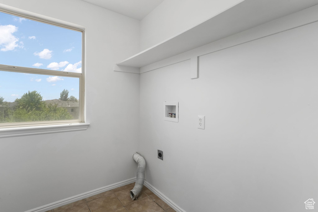 Washroom featuring electric dryer hookup, washer hookup, and tile patterned floors