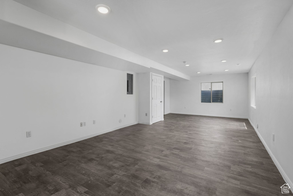 Unfurnished room with recessed lighting, dark wood-style flooring, and electric panel