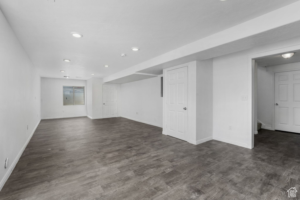 Unfurnished living room featuring dark wood finished floors and recessed lighting