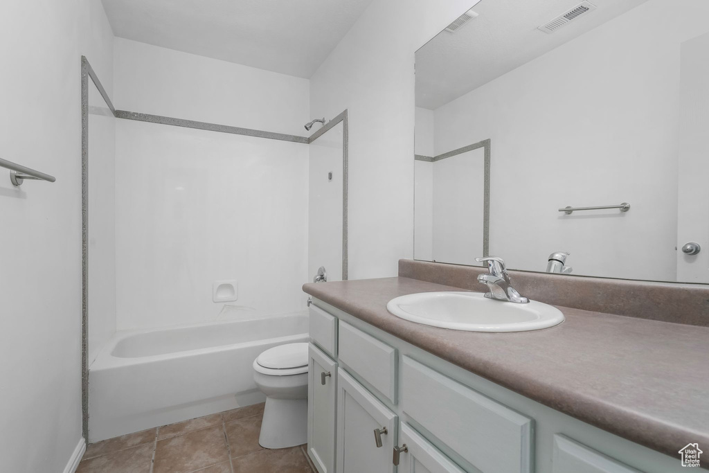 Bathroom featuring vanity, tub / shower combination, and tile patterned floors