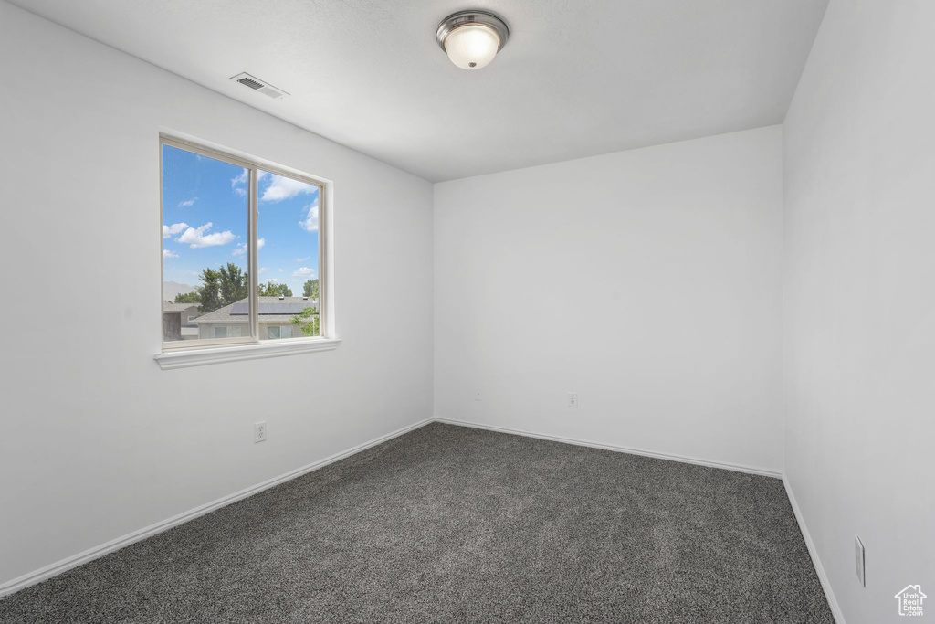 Empty room with dark colored carpet