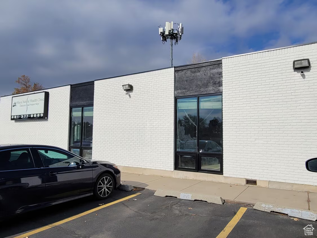 View of property featuring uncovered parking