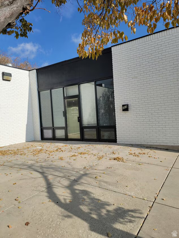 Doorway to property with brick siding