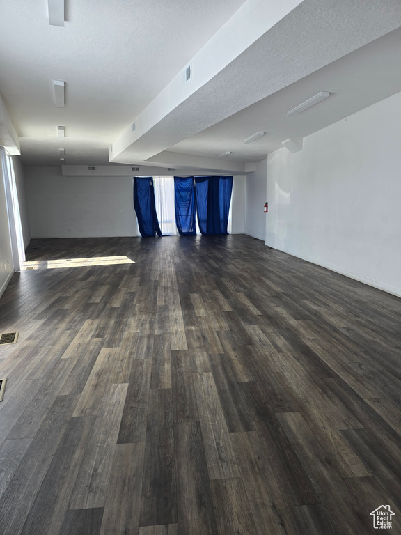 Empty room with dark wood-style flooring