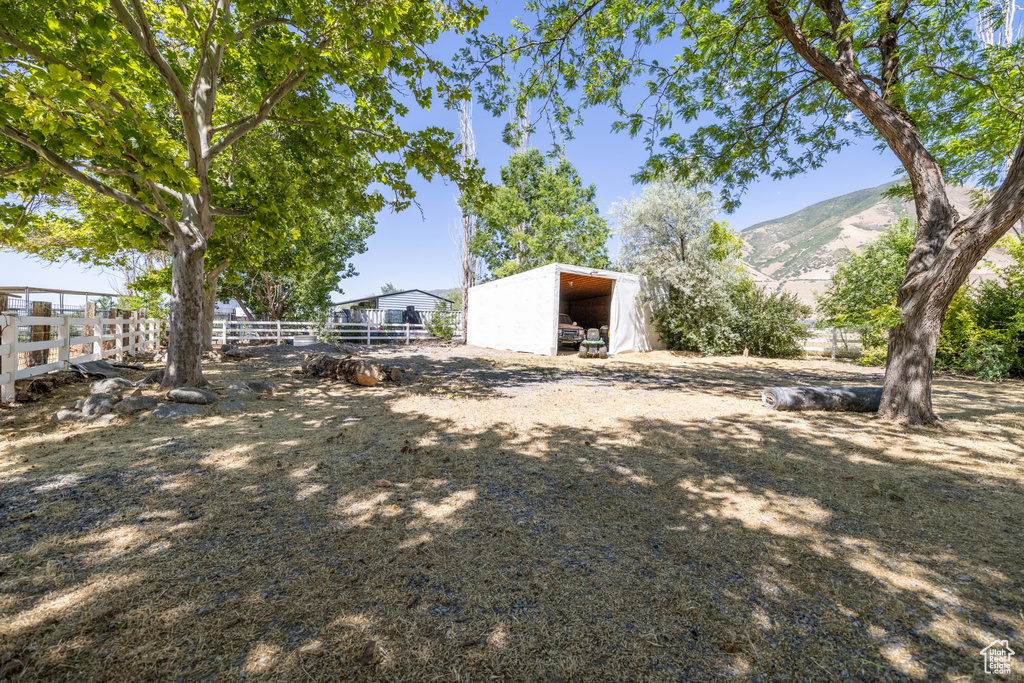 View of yard with an outbuilding and a mountain view