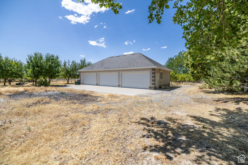 View of property exterior featuring a garage