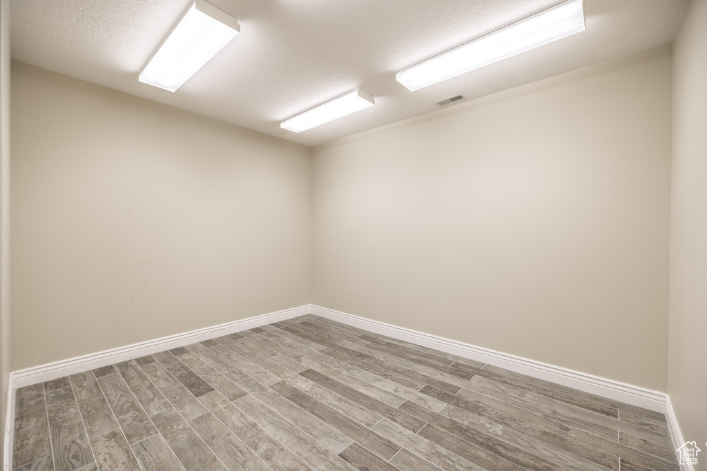 Empty room with wood finished floors and baseboards