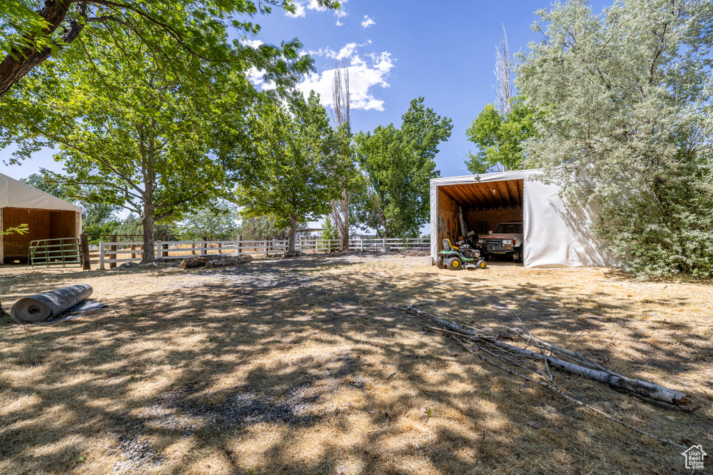 View of yard featuring an outbuilding and a carport