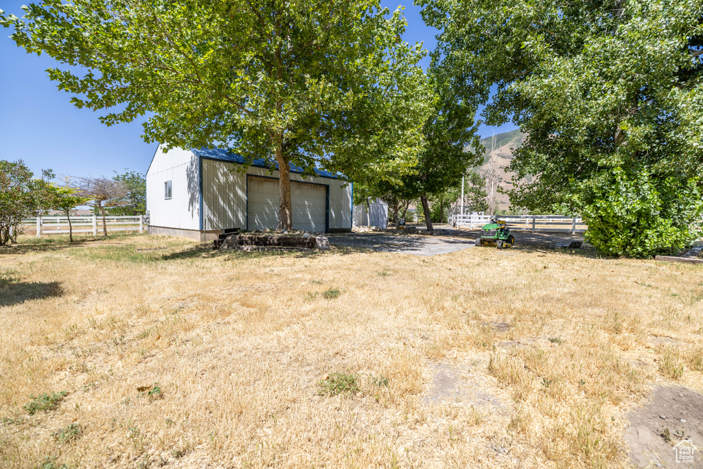 View of yard with a garage, an outdoor structure, and a mountain view
