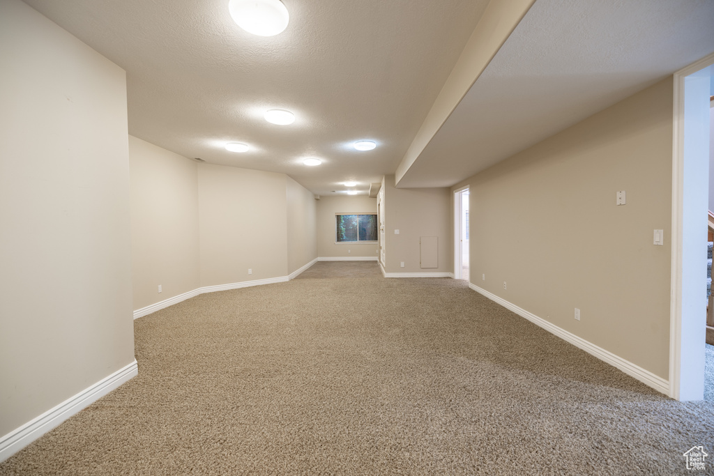Finished basement featuring carpet floors and baseboards