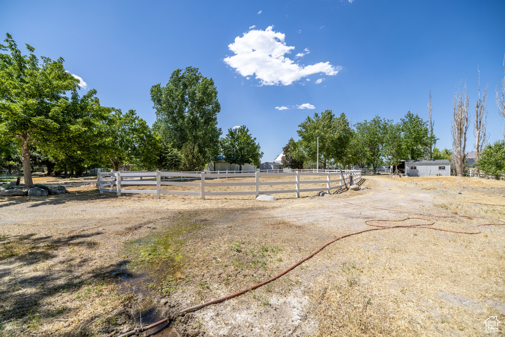 View of yard with a view of rural / pastoral area and an outdoor riding arena